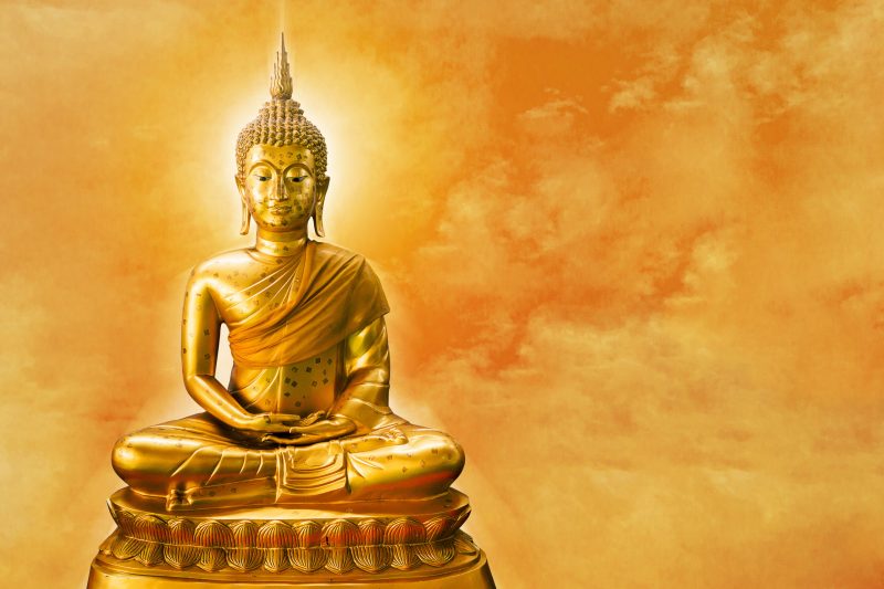 Buddha,Statue,With,Aura,On,Yellow,Sky,Background